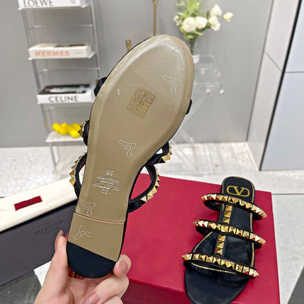 VALENTINO 26S ROCKSTUD STRAPPY FLAT SLIDE SANDALS IN BLACK CALFSKIN GOLD HARDWARE