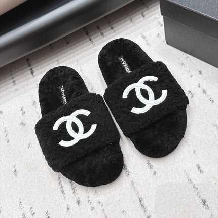 CHANEL 26S SLIDE MULES IN BLACK SHEARLING AND WHITE CC LOGO
