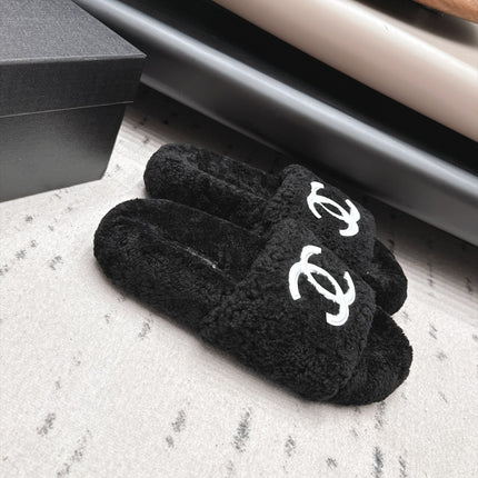 CHANEL 26S SLIDE MULES IN BLACK SHEARLING AND WHITE CC LOGO