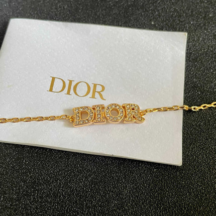 CD 26S PAVE LOGO LETTER BRACELET IN GOLD TONE METAL 631808