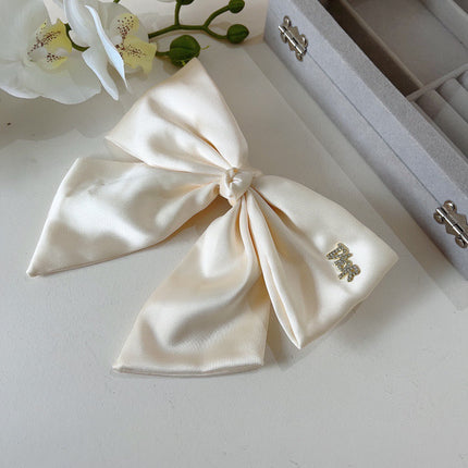 DIOR 26S BOW HAIR CLIP IN WHITE SILK 500721